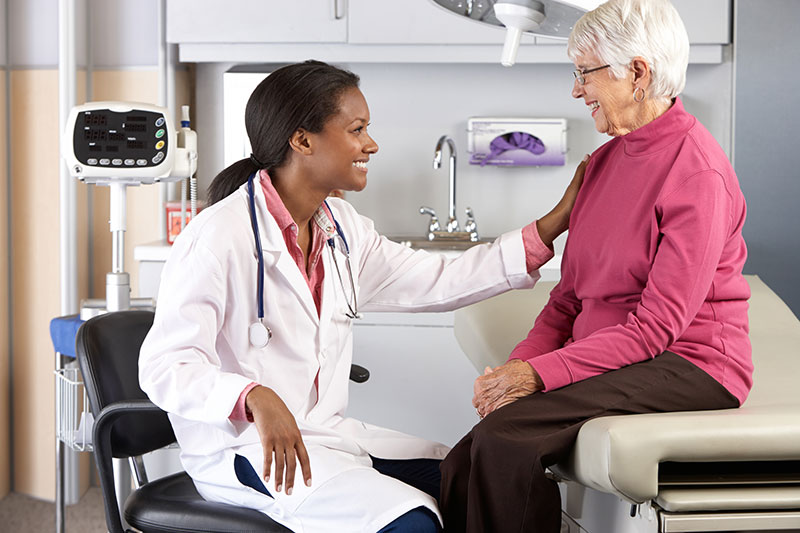 A doctor talks with a patient at a skilled nursing care facility at Booker T. Washington in Shreveport, LA