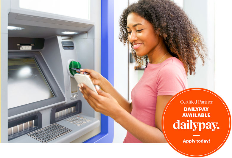 A woman uses dailypay service to withdraw money from an ATM in Shreveport, LA