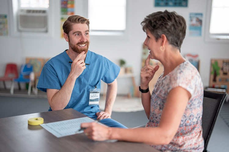 A speech language pathologist does speech exercises with a senior woman in a skilled nursing facility in Shreveport, LA